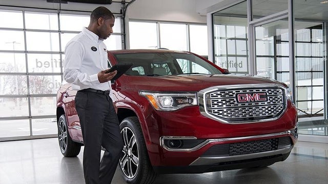 A Trained Service professional inspecting a vehicle