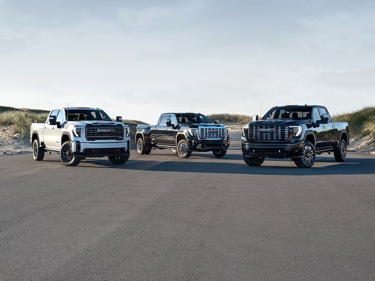 Lineup of 2025 GMC Sierra HD Trucks Parked Near Each Other